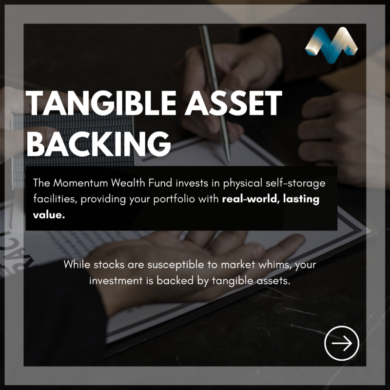 Image of a person reviewing documents with a pen, with an overlay text reading 'TANGIBLE ASSET BACKING.' The caption highlights how the Momentum Wealth Fund invests in physical self-storage facilities, providing lasting value backed by tangible assets, unlike stocks that are subject to market fluctuations.