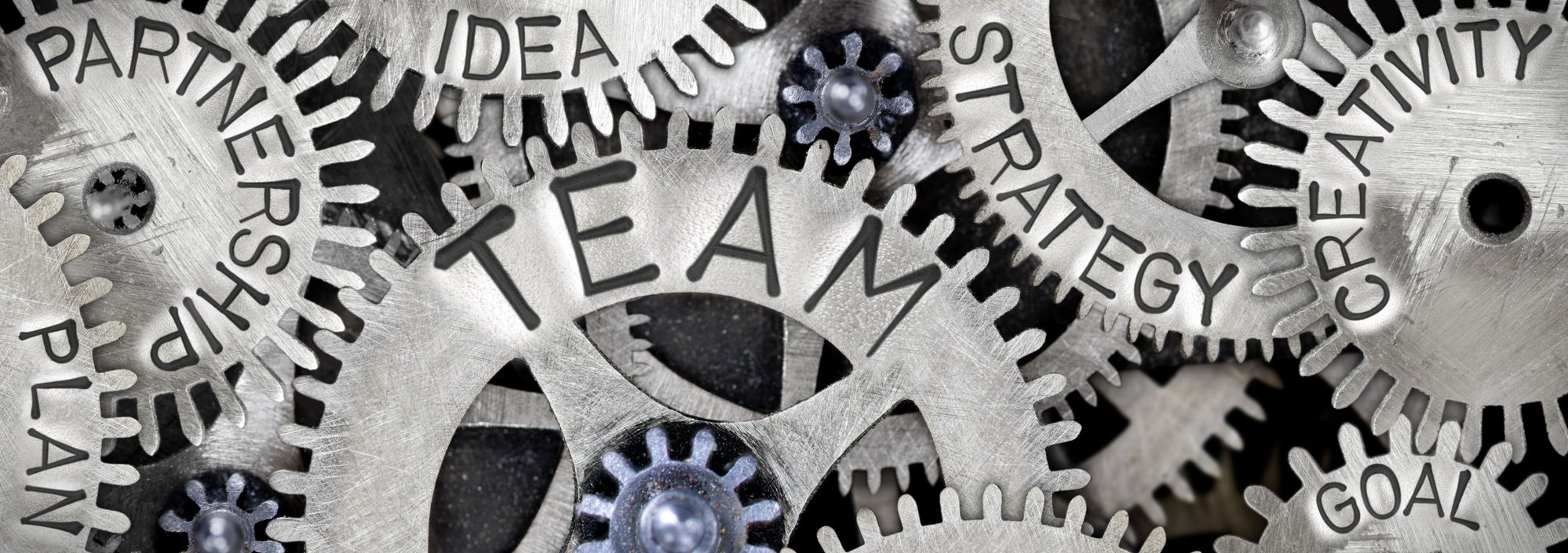 Gears engraved with team, partnership, strategy and creativity concepts